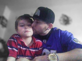 Man kissing son on the cheek