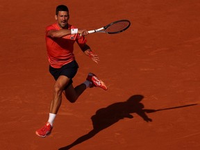 Novak Djokovic plays a forehand.