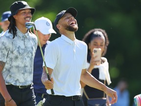 Stephen Curry laughs while playing golf.