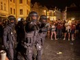 Czech riot police controls a crowd.