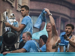 Manchester City's Rodri holds the European Cup as he celebrates.