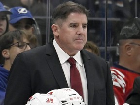 Peter Laviolette stands behind the bench.