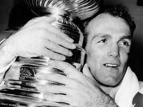 Montreal Canadiens forward Henri Richard hugs the Stanley Cup in 1966.