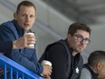 Jason Spezza and Kyle Dubas watch practice.