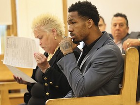 New England Patriots cornerback Jack Jones is seated at his arraignment on gun charges.