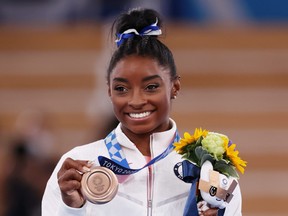 Simone Biles of Team United States poses with the bronze medal at the Tokyo 2020 Olympic Games.