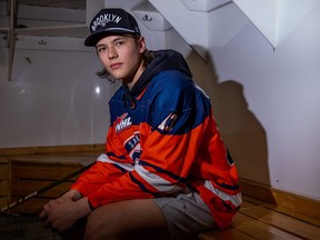 Hudson Malinoski sits in a locker room