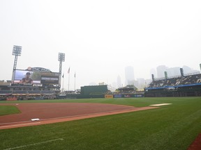 Smoke clouds the city of Pittsburgh before the game between the Pirates and San Diego Padres.