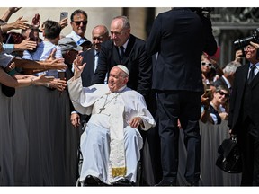 Pope Francis waves to attendees