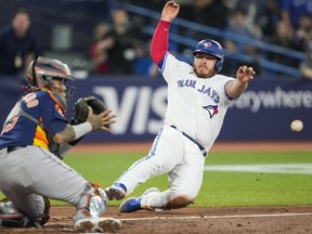Blue Jays' Alejandro Kirk is out at the plate against Martin Maldonado of the Houston Astros during the fifth inning at the Rogers Centre on Thursday, June 8, 2023 in Toronto.