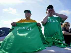 Oakland Athletics fans are handed free protest T-shirts.