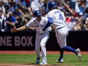 George Springer of the Toronto Blue Jays celebrates his home run against the Oakland Athletics with Mark Budzinski #53 during the first inning in their MLB game at the Rogers Centre on June 25, 2023.