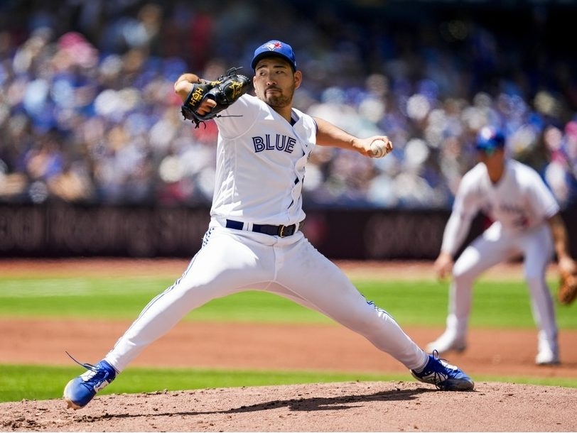 Yusei Kikuchi of the Toronto Blue Jays smiles at the end of the