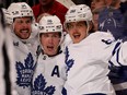 Auston Matthews, Mitch Marner and William Nylander celebrate a goal.