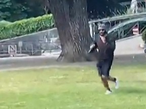 A screen grab taken from a video obtained by AFPTV on June 8, 2023 shows a man armed with a knife running away after he attacked a group of pre-school children