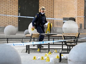 A police forensic officer works at the scene of a shooting incident at Farsta shopping center in the south of Stockholm on June 10, 2023.
