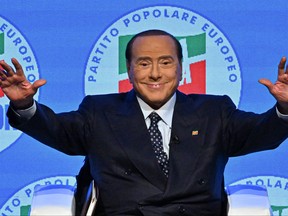 In this file photo taken on September 23, 2022 the leader of Italian right-wing party "Forza Italia", Silvio Berlusconi acknowledges applause on stage at the Manzoni theater in Milan during a meeting closing his party's campaign for the September 25 general election.