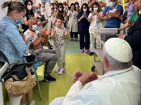 This photo taken and issued as a handout by the Vatican media on June 15, 2023 shows Pope Francis visiting the paediatric oncology and child neurosurgery ward, adjacent to the flat where he is convalescing, at the Gemelli hospital in Rome.