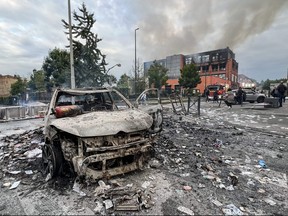 A burnt-out vehicle stands on a street in front of the fire damaged Tessi group building in the Alma district of Roubaix on June 30, 2023, which was completely destroyed by fire during protests after a 17-year-old boy was shot in the chest by police at point-blank range in Nanterre, a western suburb of Paris.