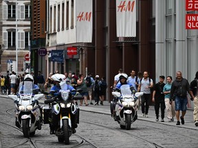 Policemen ride their motorbikes
