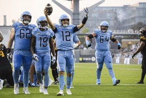 Toronto Argonauts quarterback Chad Kelly celebrates after scoring against the Hamilton Tiger-Cats at BMO Field yesterday. The Argonauts won 32-14. Christopher Katsarov/The Canadian Press