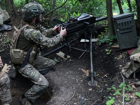 Ukrainian soldier of the 28th Separate Mechanized Brigade fires a 40mm grenade launcher at the front line near the town of Bakhmut, Donetsk region
