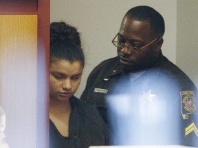 Heather Leavell-Keaton, 22, left, is led into the courtroom