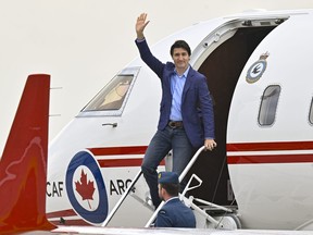 Prime Minister Justin Trudeau waves as he steps off a plane, Wednesday, June 14, 2023 at CFB Bagotville in Saguenay, Que.