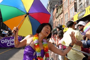 Toronto mayoral candidate Olivia Chow high fives a spectator as she walks in the Toronto Pride Parade, on Sunday June 25, 2023. THE CANADIAN PRESS/Chris Young