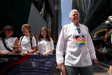 Former Maple Leafs president Brian Burke walks in the Toronto Pride Parade.
