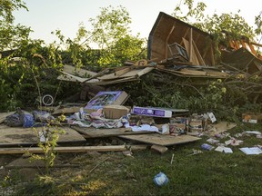 Debris is left behind after a reported tornado touched down in several areas of Greenwood, Ind.
