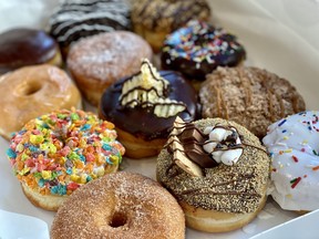 Different doughnuts topped with a variety of sweet and colourful toppings.