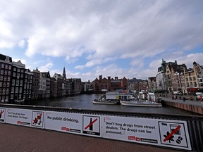 Amsterdam city centre with signs deterring people from smoking, drinking