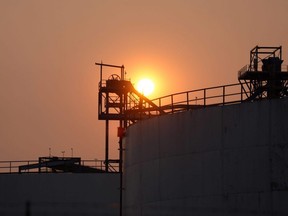Smoke from a refinery in Hamilton, Ont. rises against a setting sun, as smoke from wildfires blankets the sky on Wednesday, June 7, 2023.