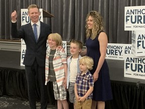Mayoral candidate Anthony Furey gives a thumbs up alongside his family Monday at his headquarters in Scarborough.