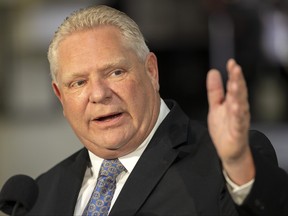 Doug Ford gestures with his hand.