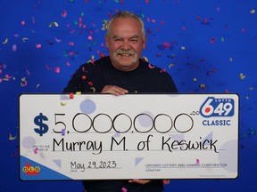 ManMurray Mainprize after winning a $5-million Lotto 6/49 jackpot. holding giant $5-million cheque.