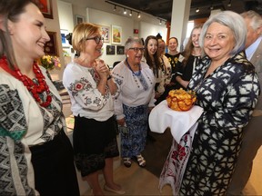 Members of Winnipeg’s Ukrainian community present Governor General Mary Simon (right) with a round bread as a greeting