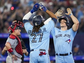 Blue Jays' Matt Chapman, right, celebrates his home run with Vladimir Guerrero Jr. against the Twins during the fifth inning at the Rogers Centre in Toronto, Sunday, June 11, 2023.