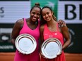 Taylor Townsend, left, and Leylah Fernandez pose with their trophy after being defeated by Wang Xinyu and Hsieh Su-wei during their women's doubles final match at the French Open in Paris, Sunday, June 11, 2023.