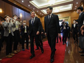 U.S. Secretary of State Antony Blinken (left) walks with China's Foreign Minister Qin Gang
