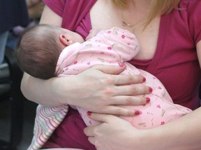 A mother breastfeeds her baby.