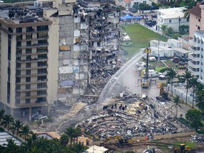Rescue personnel work at the remains of the Champlain Towers