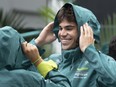 Aston Martin driver Lance Stroll, from Canada, puts on his rain jacket at the Canadian Grand Prix Thursday, June 15, 2023 in Montreal.THE CANADIAN PRESS/Ryan Remiorz