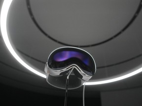 The Apple Vision Pro headset is displayed in a showroom