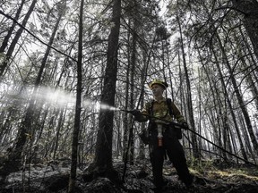 firefighter Kalen MacMullin of Sydney, N.S. works on a fire in Shelburne County, N.S.