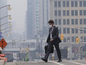 A man walks to work wearing a mask near Parliament Hill