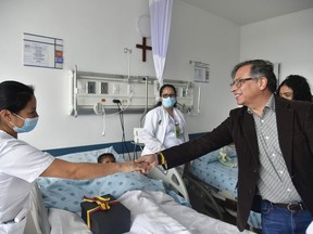 Colombian President Gustavo Petro greets a nurse.