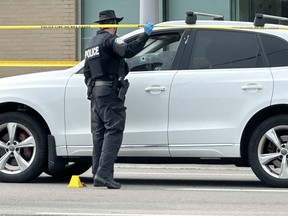 Toronto Police cordoned off a section of Ellesmere Rd. just east of McCowan Rd., where a white SUV with its driver's side window shot up could be seen, after a drive-by shooting sent a man and a woman to hospital on Friday, June 30, 2023.