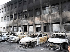 Seven burnt out vehicles are seen outside the municipal police building in Neuilly-sur-Marne